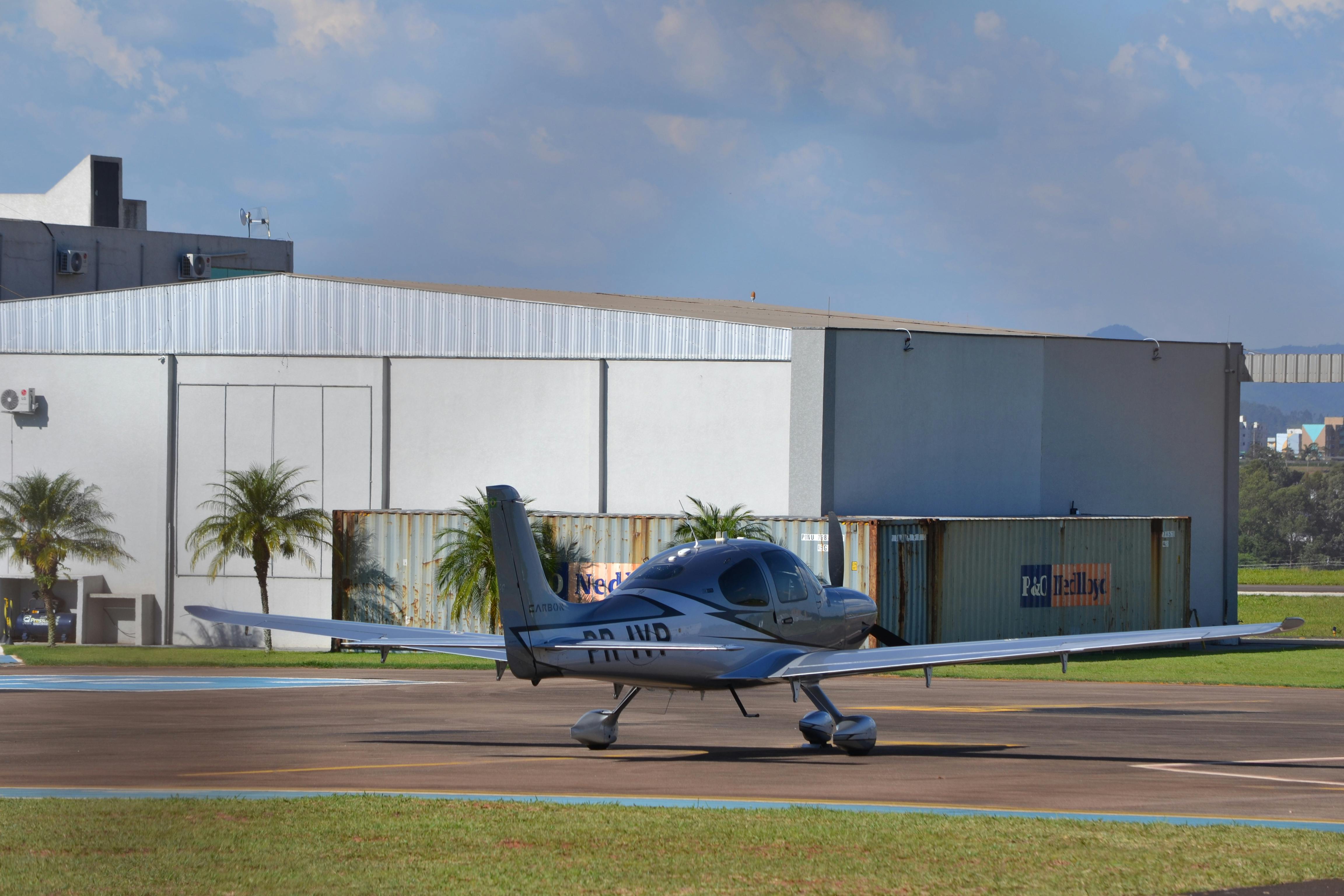 Private aircraft on the runway outside a hangar