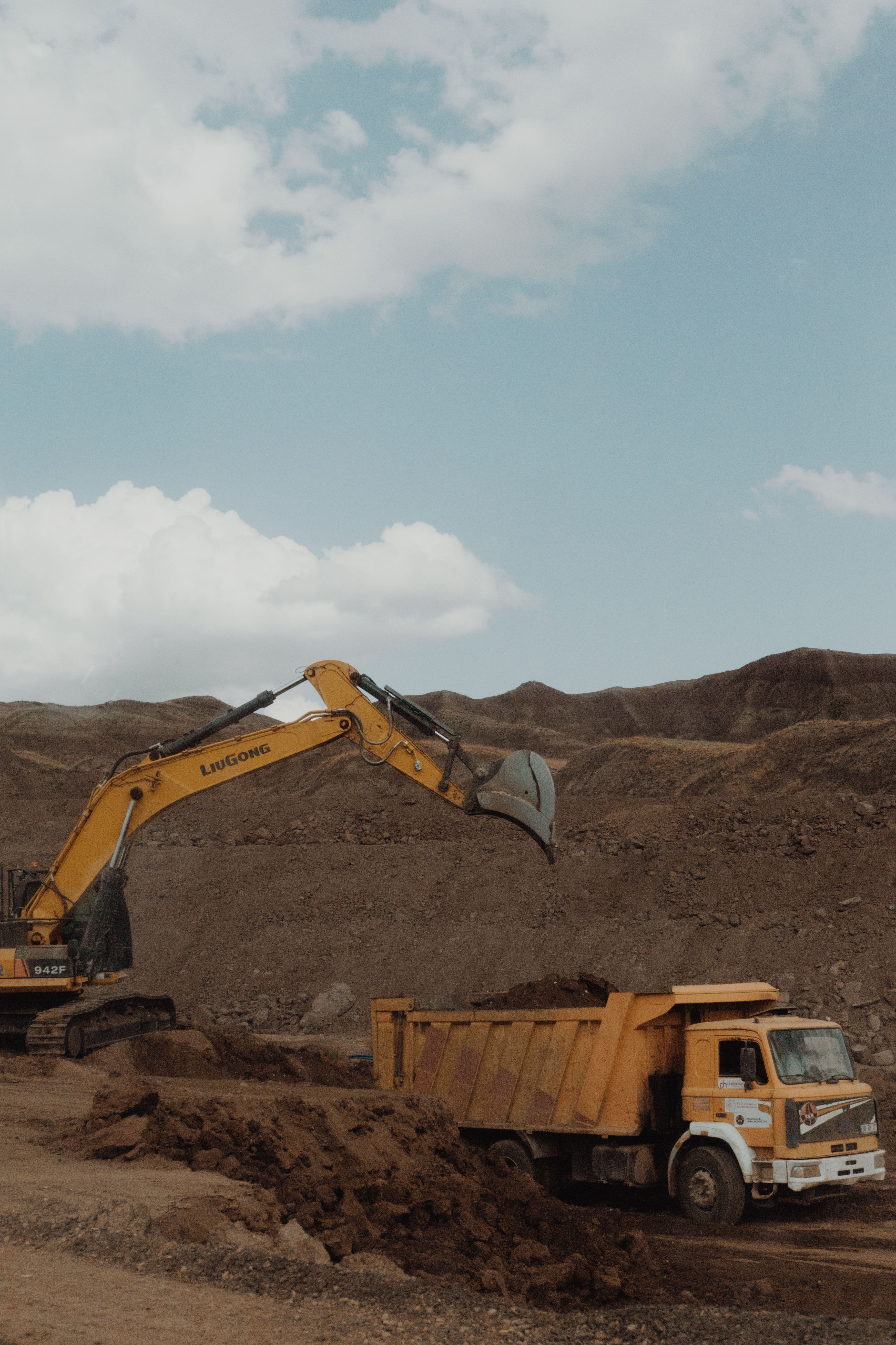 Excavator and dump truck operating at a mining site