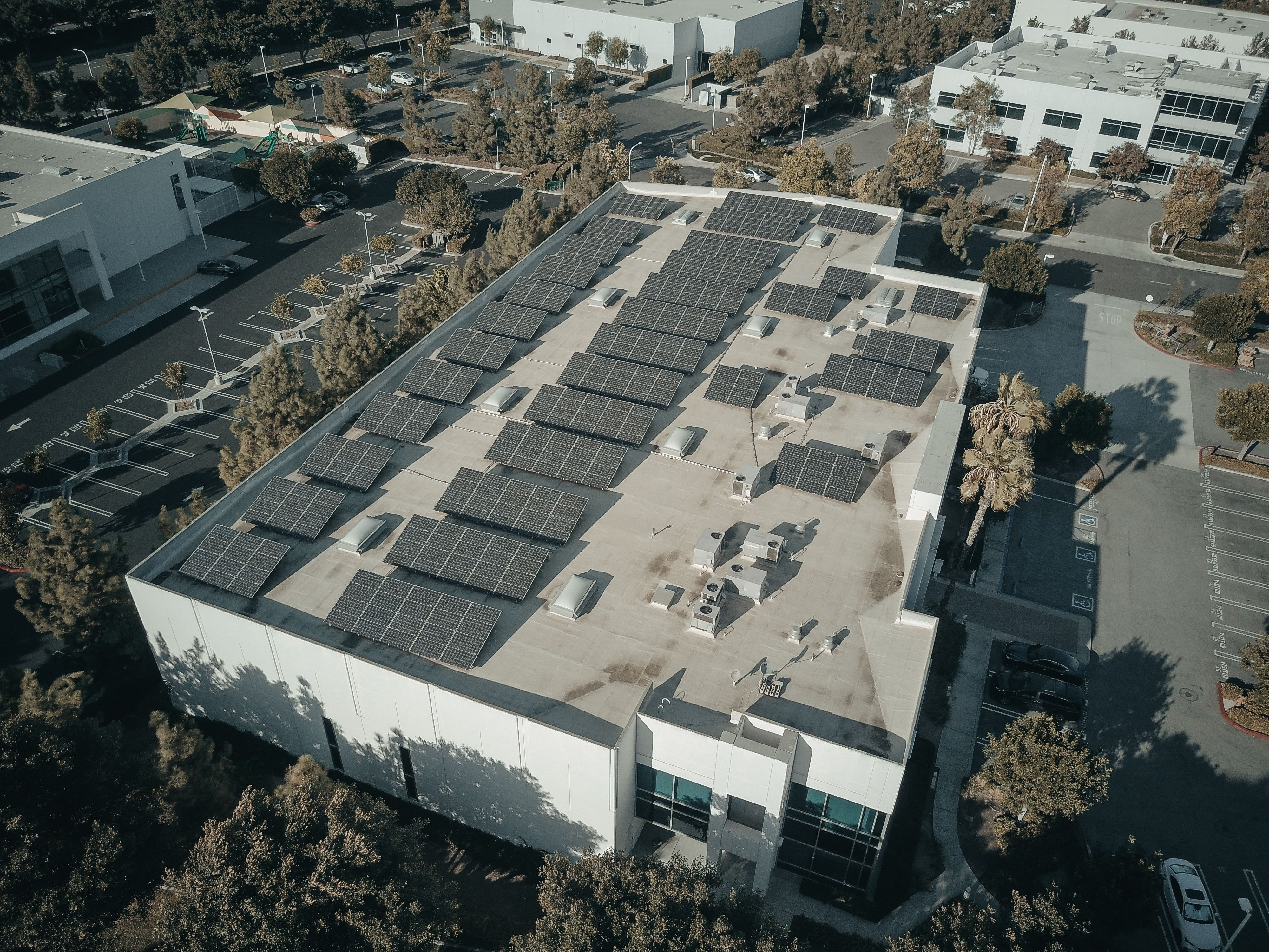 Aerial view of a commercial building with rooftop solar panels